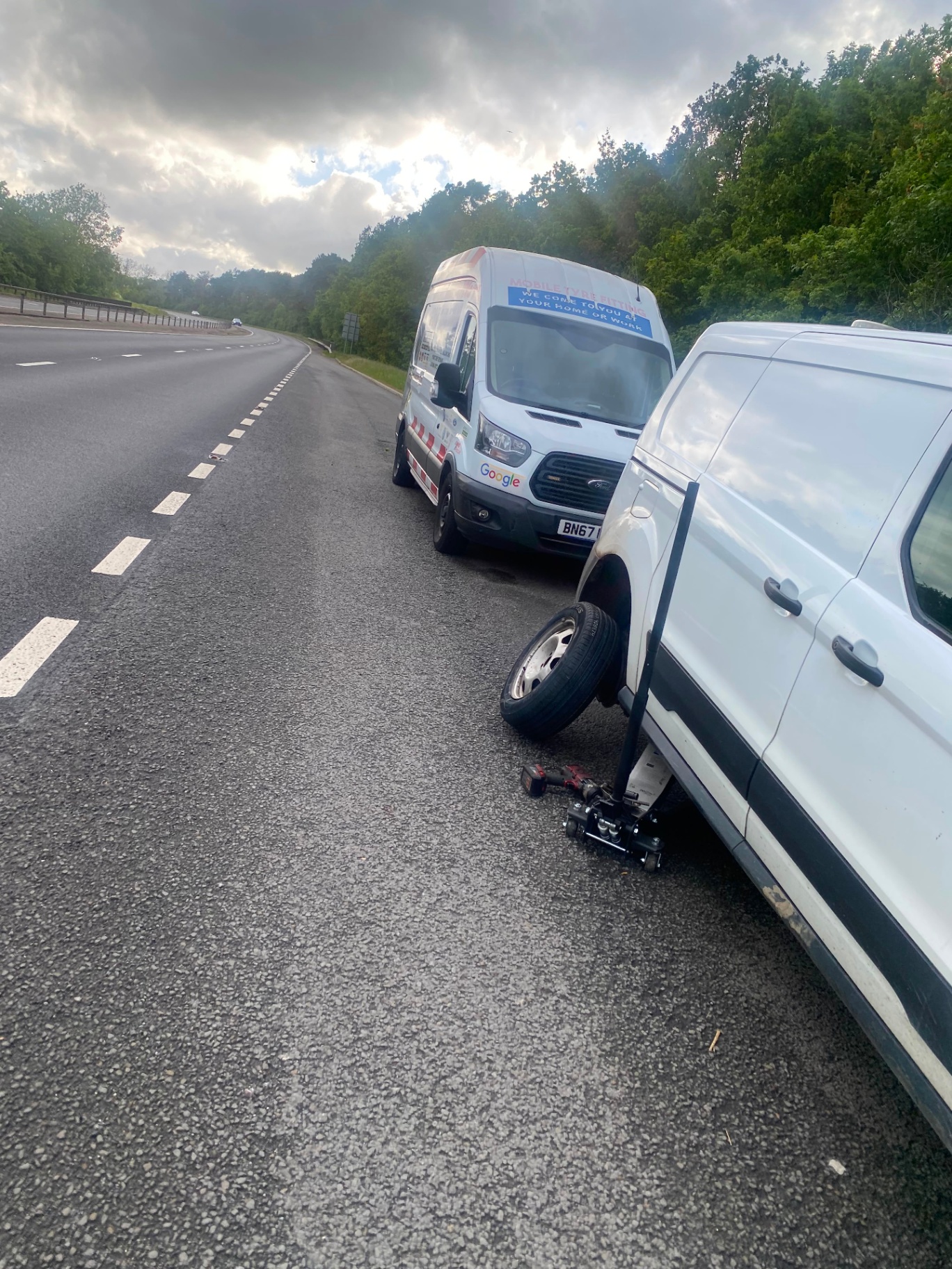 24/7 emergency roadside tyre response — Mobile Tyre Fitter 247 van attending a stranded vehicle on the motorway hard shoulder