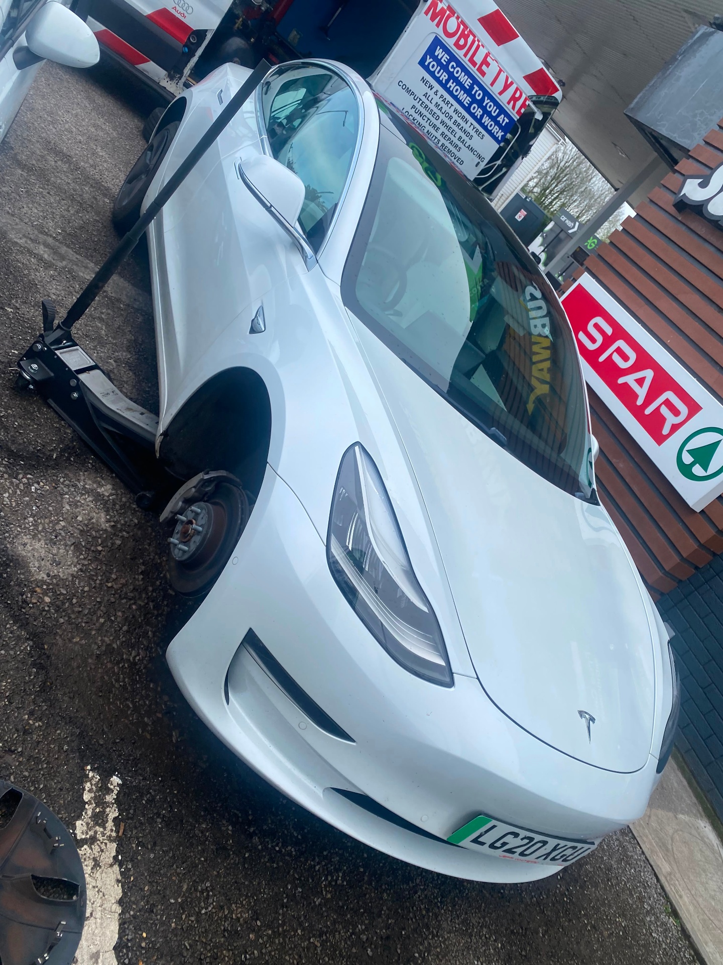 Mobile tyre fitting on a Tesla Model 3 at a forecourt
